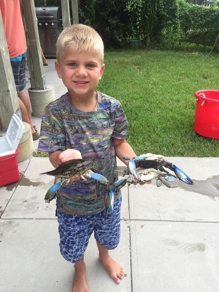 Boy with blue crabs at The Fish House